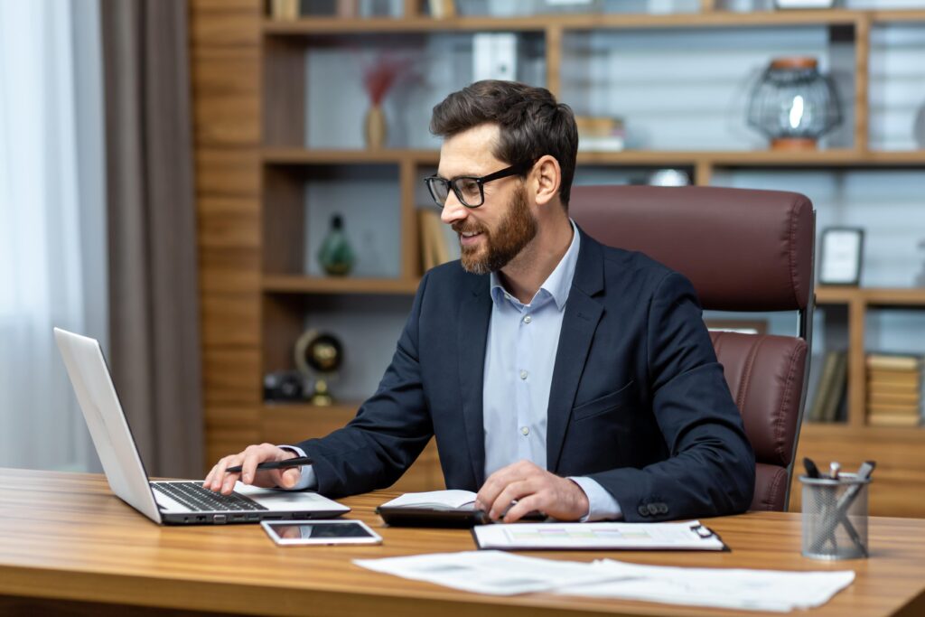 happy businessman working in the office and enjoying getting online business